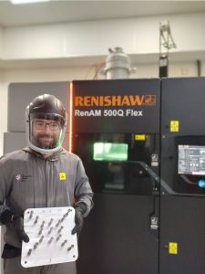 Two men in full body ppe Renishaw helping Irish Manufacturing Research